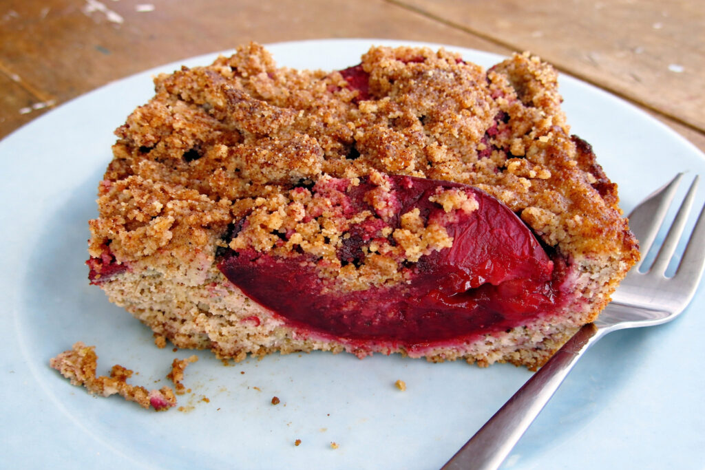 Plum Hazelnut Crumble Cake (Vegan, Gluten-free) 3 Close-up of juicy plums and crunchy crumble on a vegan gluten-free cake.