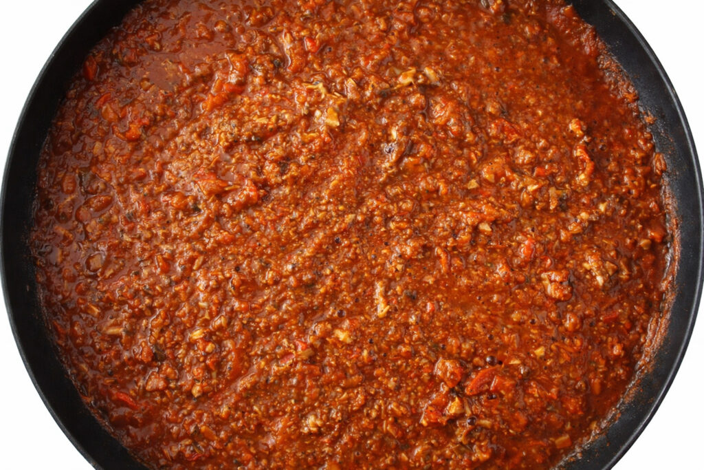Plant-based meat-free Bolognese without soy or tomato on pasta.