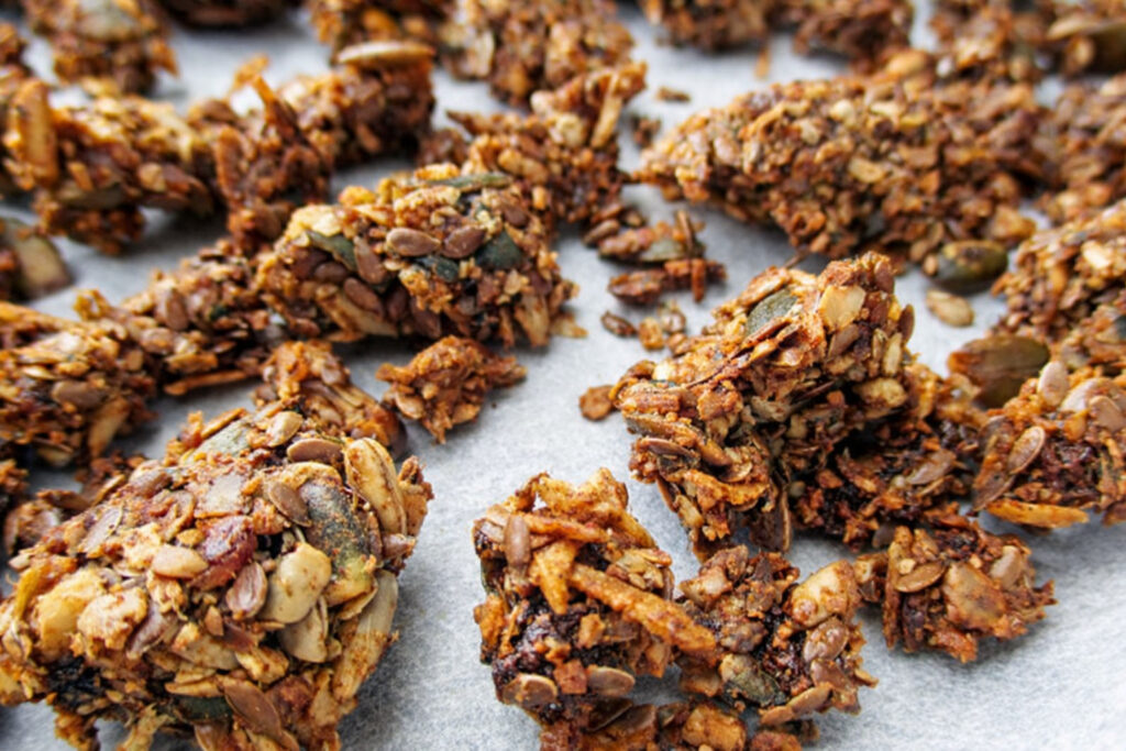 Close-up of crispy seed muesli clusters: nut-free, fruit-sweetened, gluten-free and vegan
