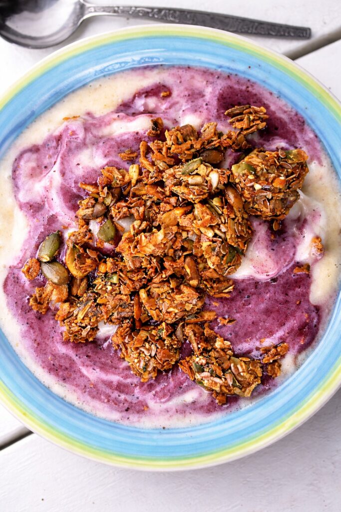 Homemade vegan & gluten-free muesli served with plant milk and fresh fruit