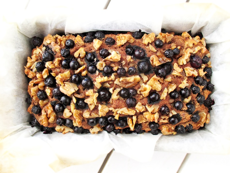 Top view of a moist vegan gluten-free banana loaf with blueberries and walnuts